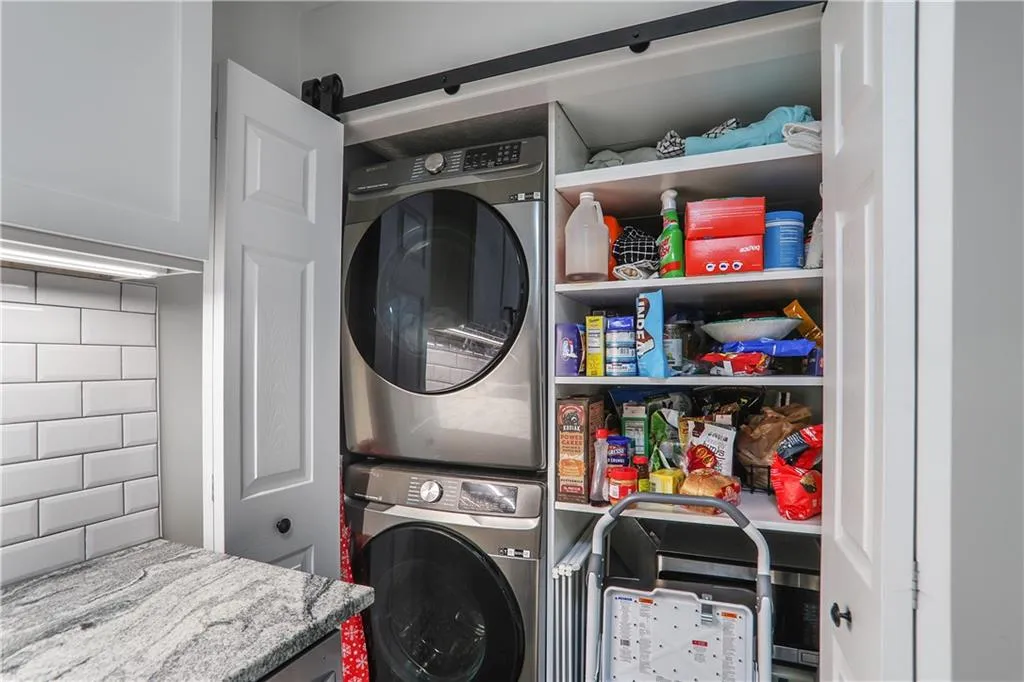 Clothes washing area with stacked washer and clothes dryer