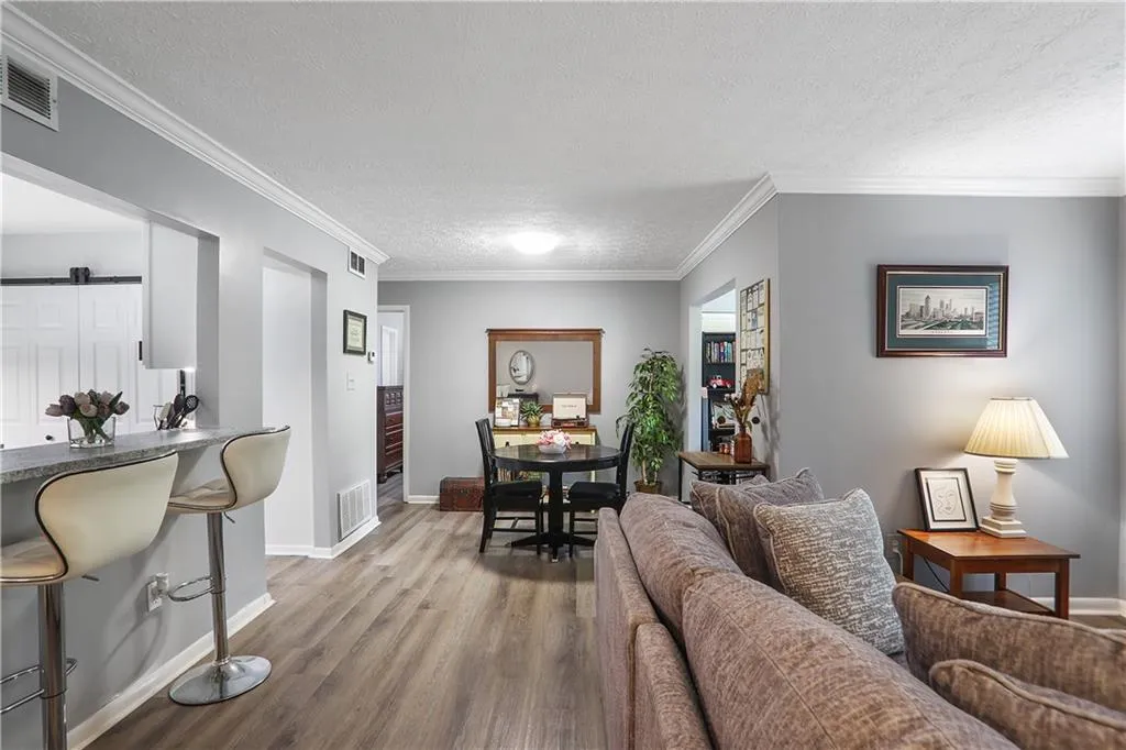 Living room featuring a barn door, a textured ceiling, and hardwood / wood-style flooring