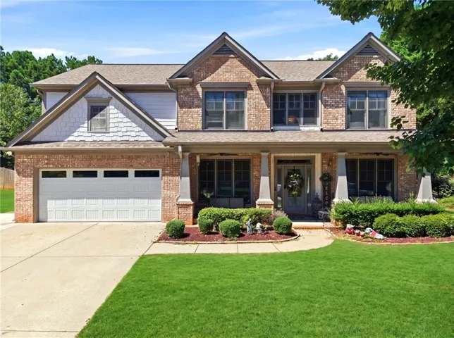 Brick exterior with white shake siding accents
