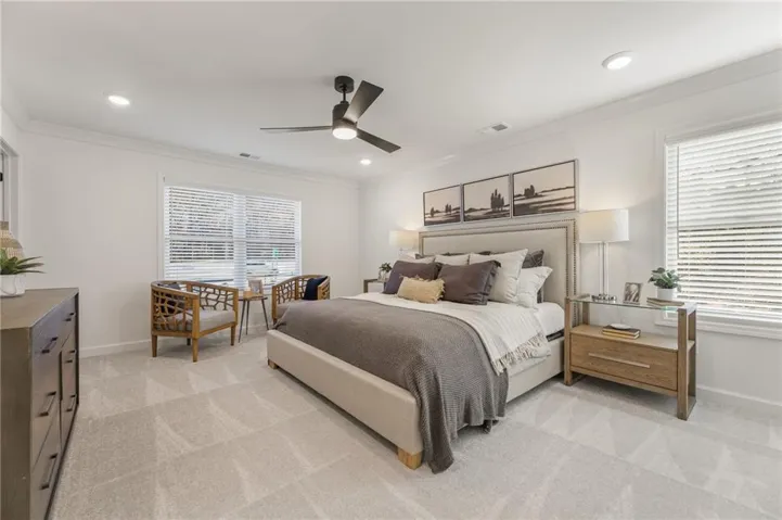 Recessed lighting, ceiling fan, crown molding, and light-colored carpeting