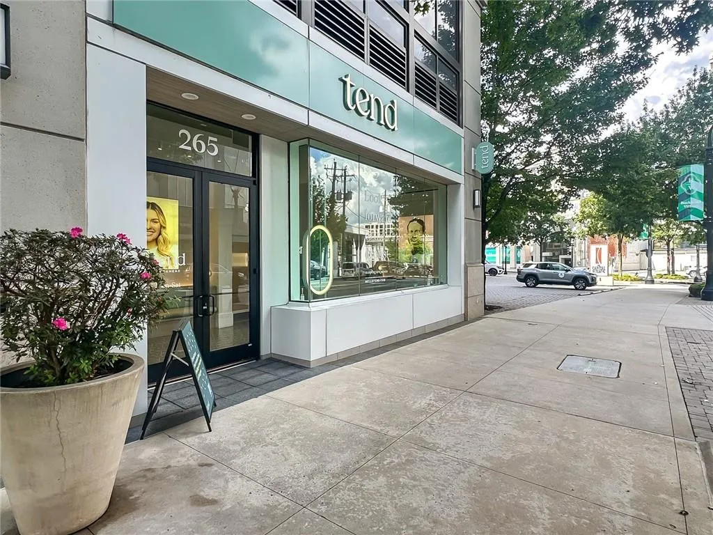 Commercial storefront with full glass entry doors and a large display window