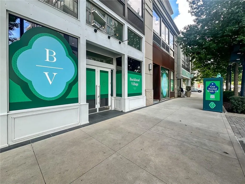 Commercial storefront featuring large display windows and a double-door entrance