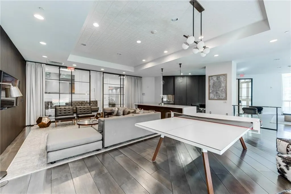 Open-concept common area featuring wood-finish flooring, recessed lighting, and a decorative ceiling panel