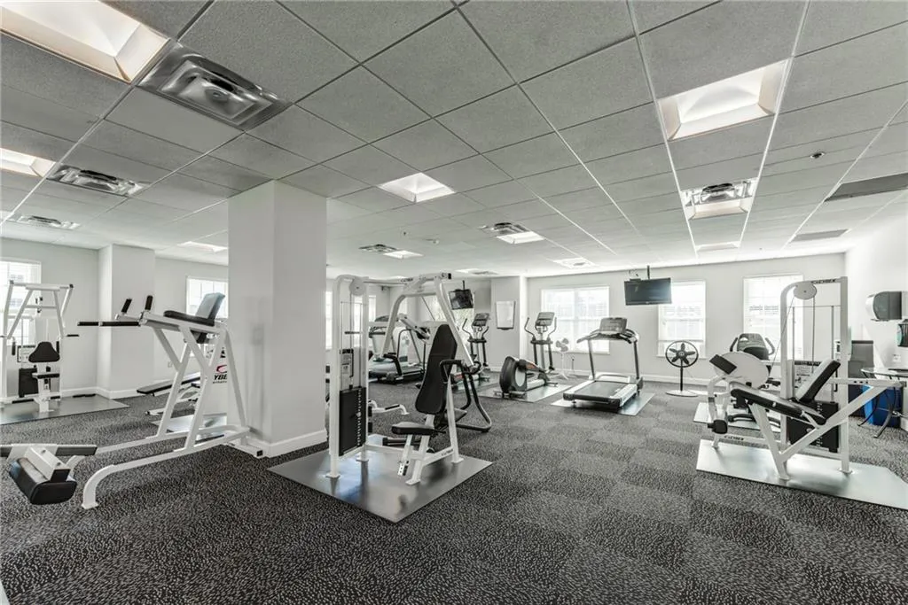 Fitness center featuring recessed lighting, multiple windows, and carpeted flooring