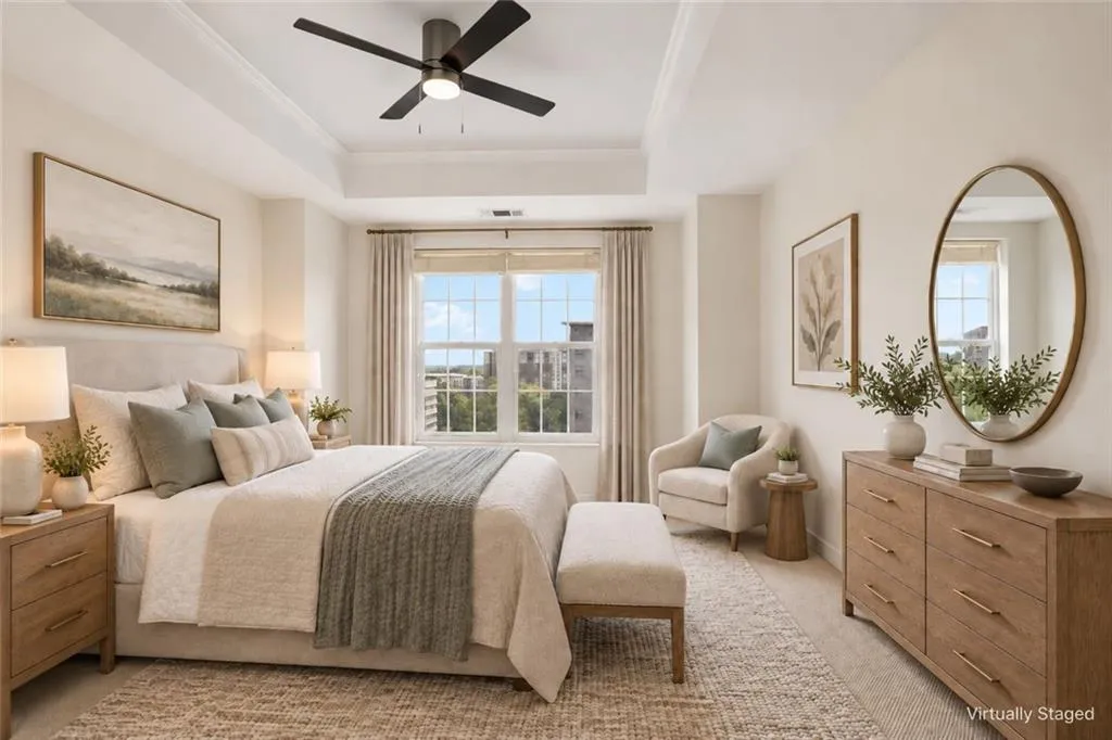 Tray ceiling with a ceiling fan, large window with blinds and curtains, and wood-finish flooring