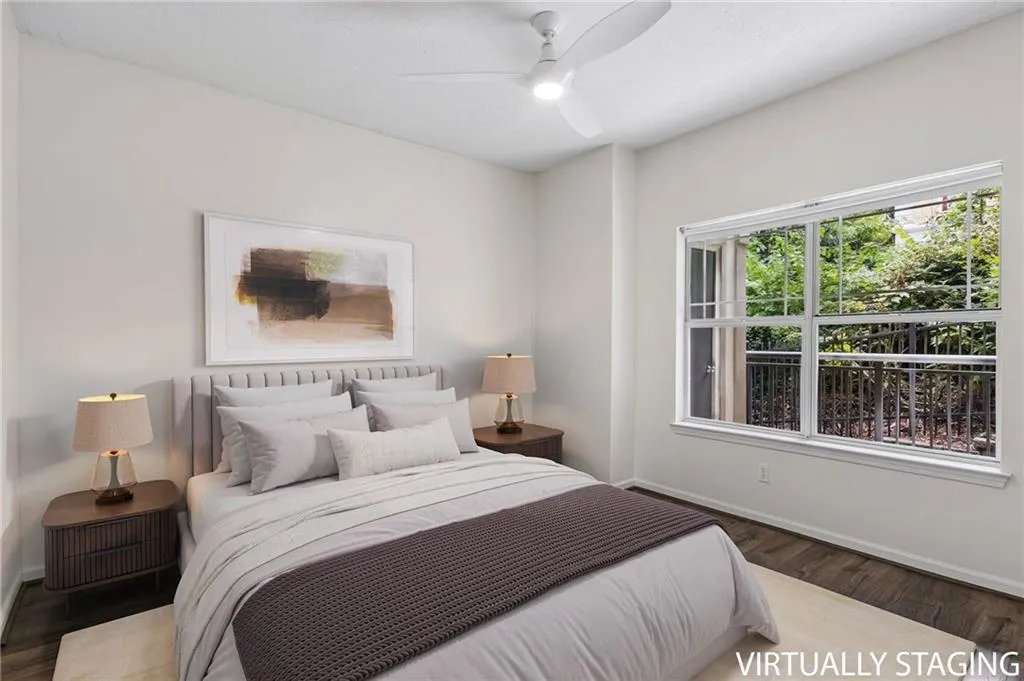 Wood-finish flooring, white walls, and a ceiling fan