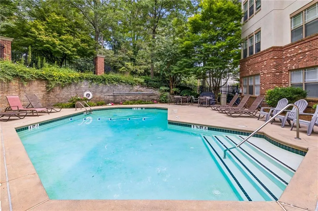 Outdoor swimming pool with integrated steps, surrounded by a concrete patio