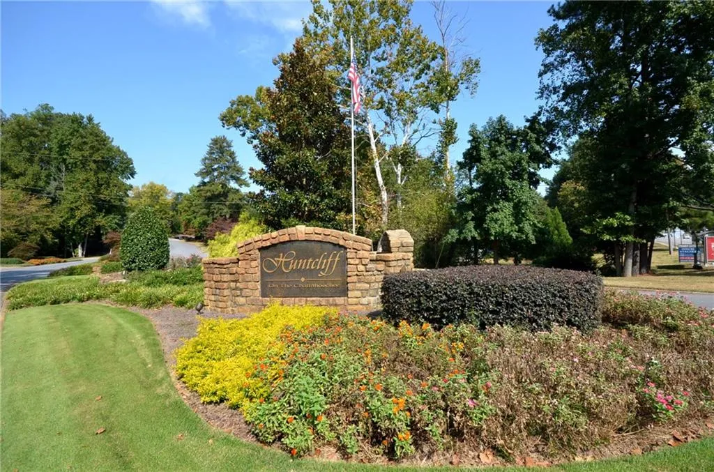 Community sign featuring view of scattered trees