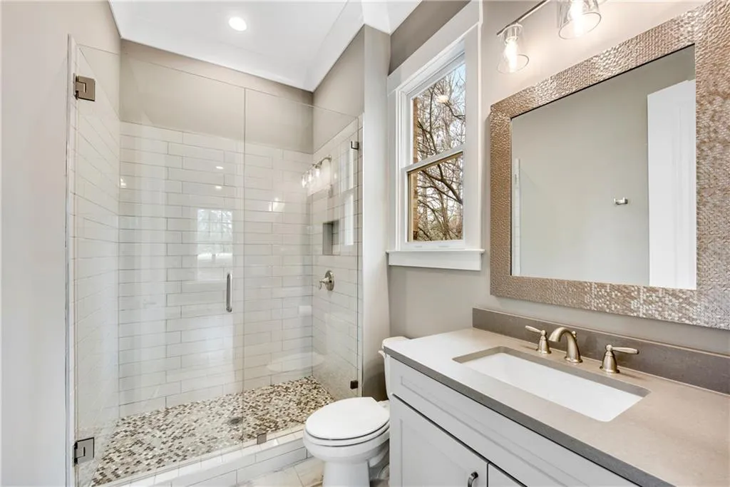 Full bathroom with a shower stall and vanity
