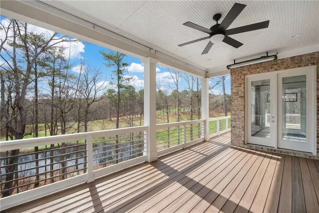 Wooden deck featuring a ceiling fan and french doors