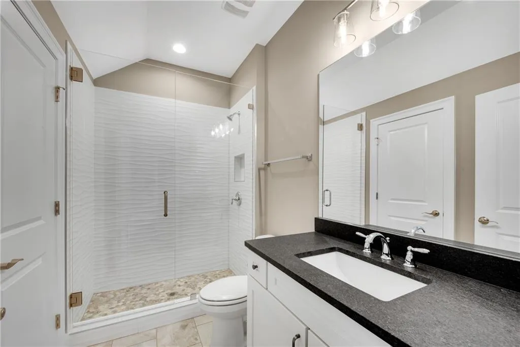 Bathroom with vanity and a shower stall