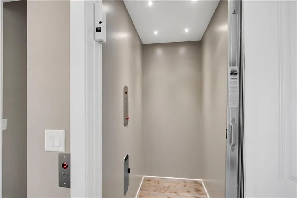 Elevator with wood finished floors and recessed lighting