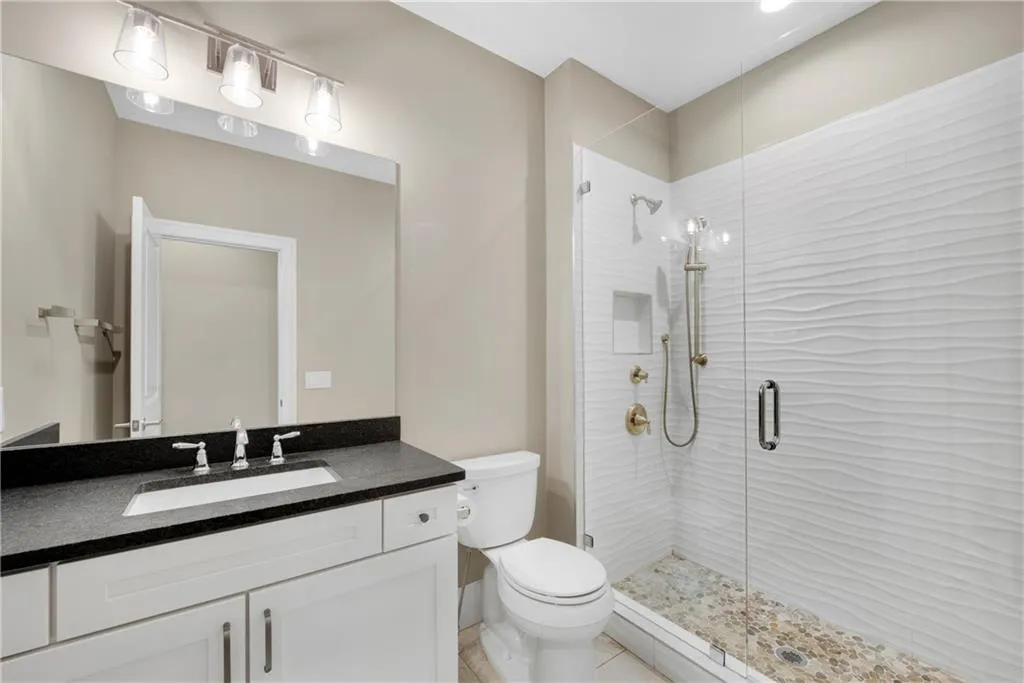 Bathroom featuring vanity and a stall shower