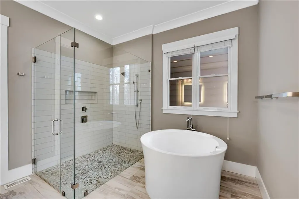 Full bathroom with a stall shower and a freestanding bath