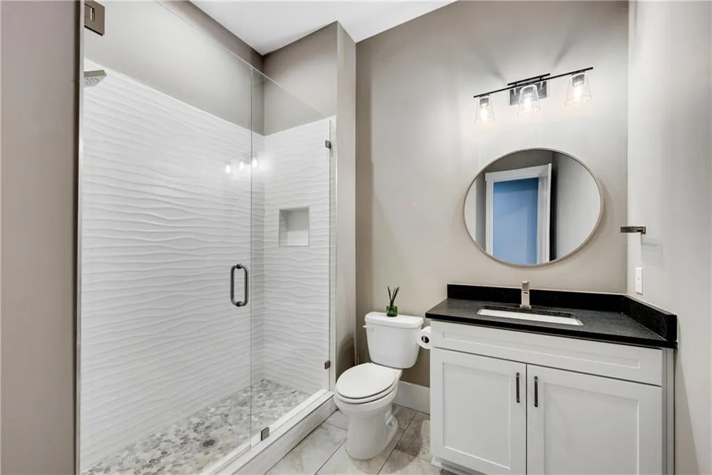 Bathroom with vanity and a stall shower