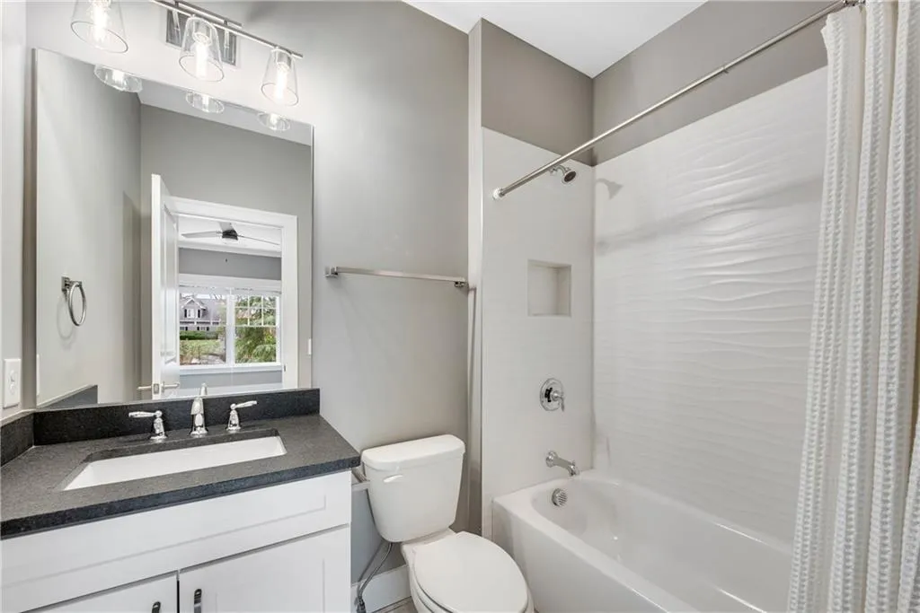 Full bath featuring vanity and shower / bathtub combination with curtain