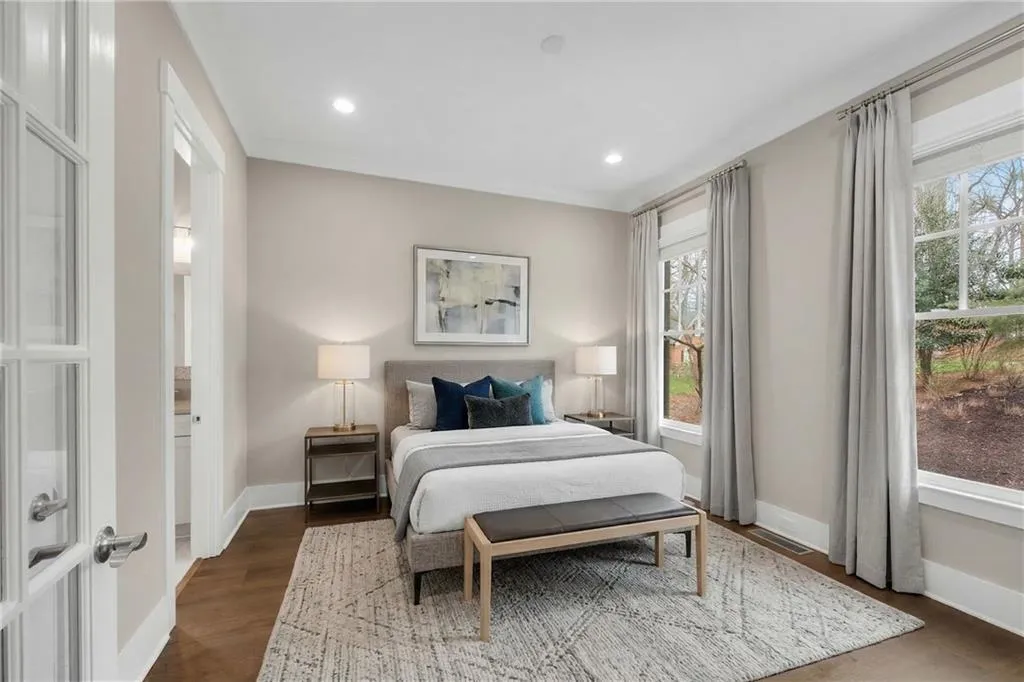 Bedroom featuring dark wood-style flooring, recessed lighting, and ensuite bathroom