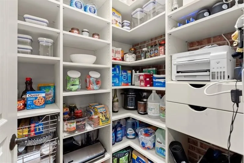 Walk-in pantry with solid shelving.