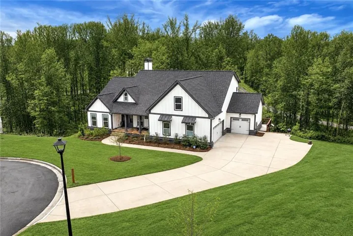 White board-and-batten siding with dark trim accents