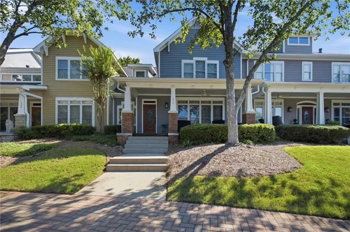 Brick paver sidewalk, concrete walkway, and manicured lawn