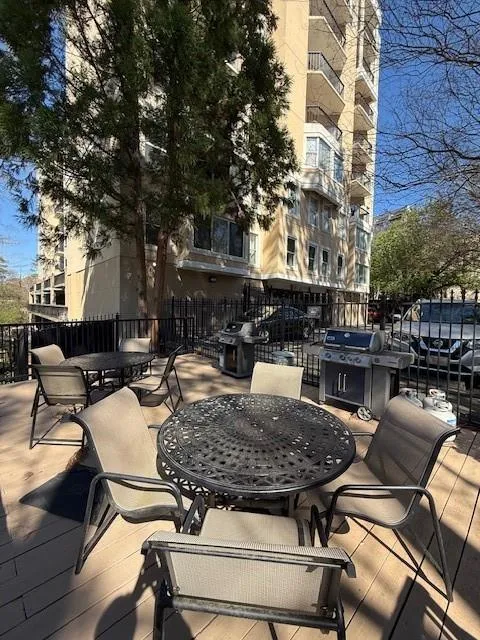 View of patio / terrace with outdoor dining space, grilling area, and a wooden deck