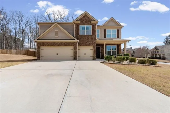 Traditional two-story residence featuring a brick and siding exterior
