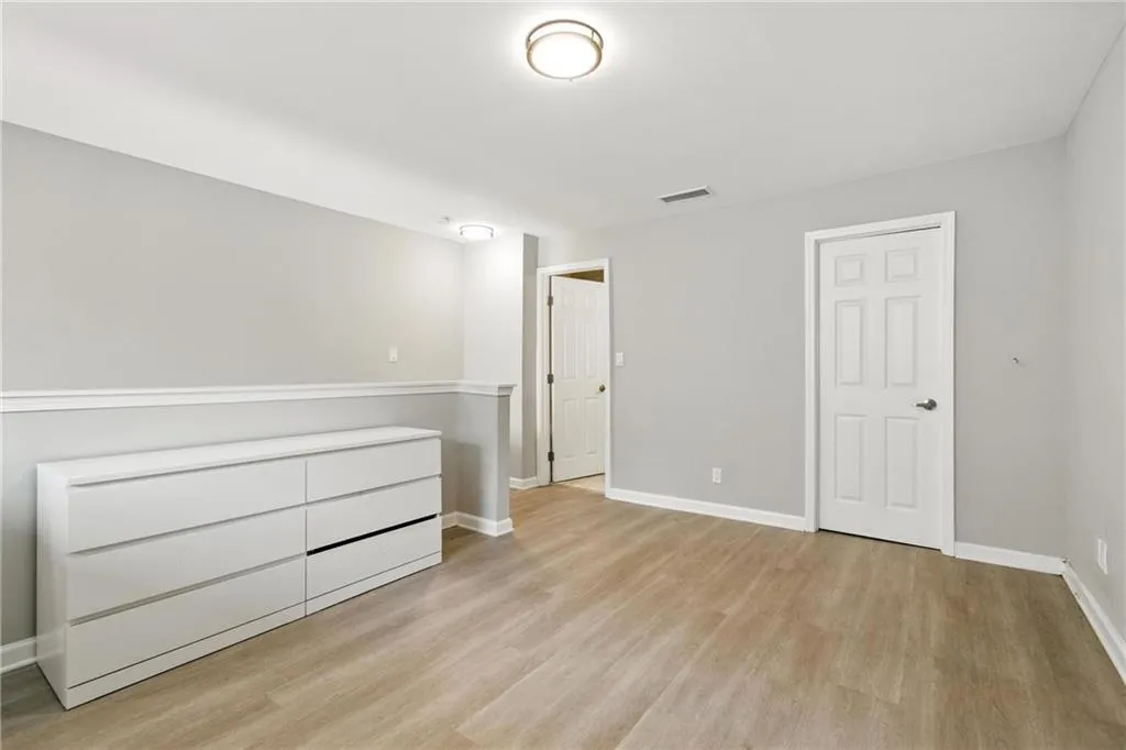 Unfurnished bedroom featuring light wood-type flooring and baseboards
