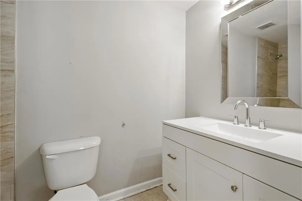 Full bathroom with toilet and vanity