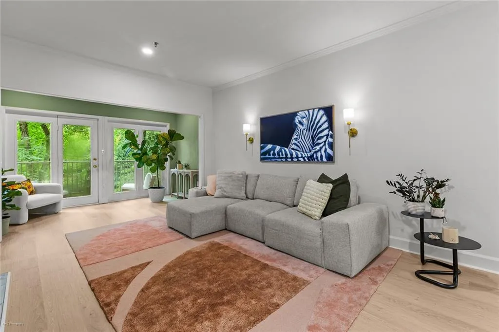 Living area with wood finished floors, ornamental molding, and recessed lighting