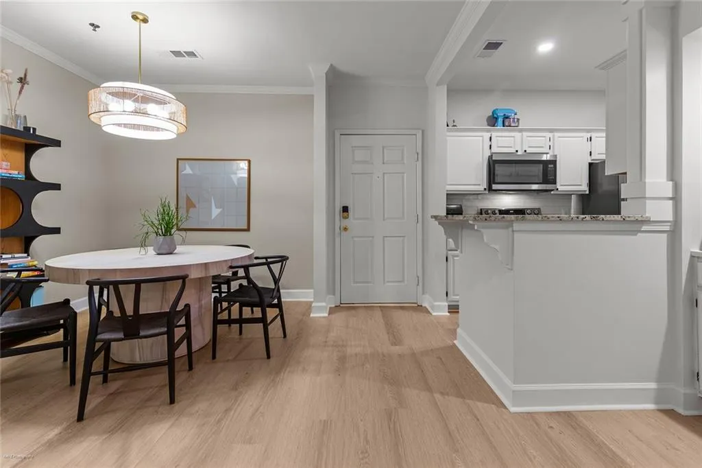 Dining area featuring crown molding and light wood finished floors