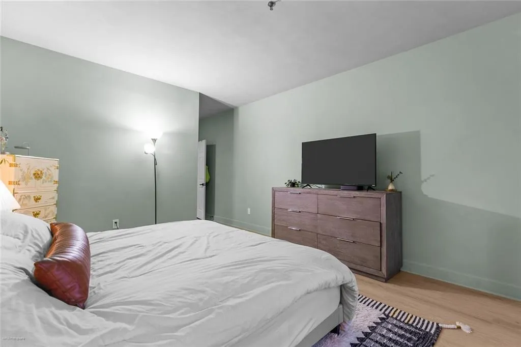 Bedroom with light wood-type flooring and baseboards