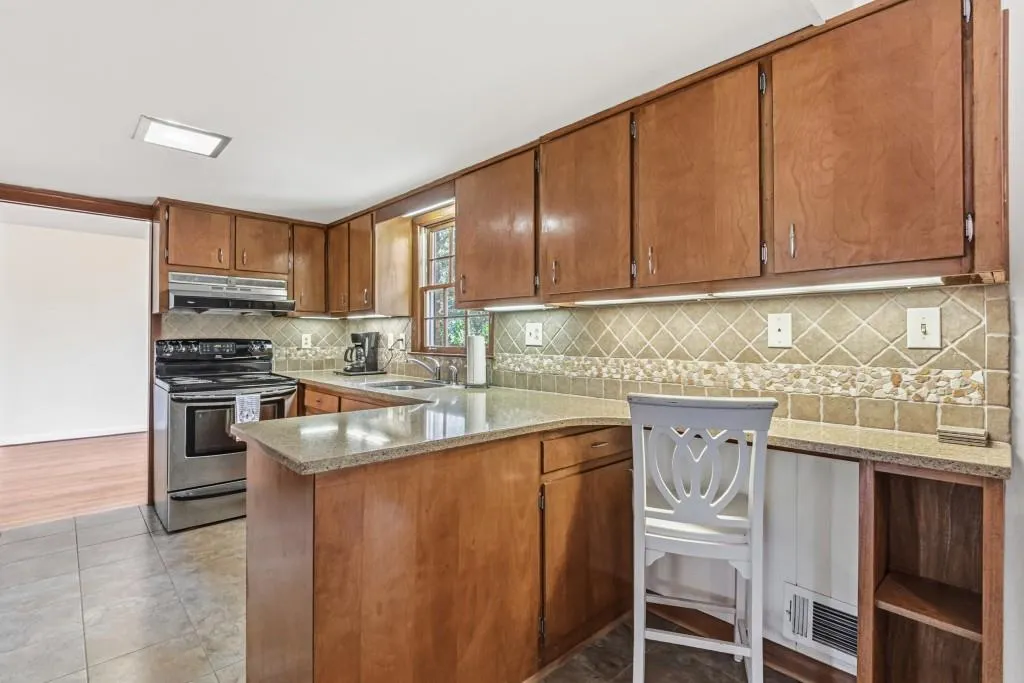 Kitchen with Quartz counters, ceramic tile backsplash and SS Appliances