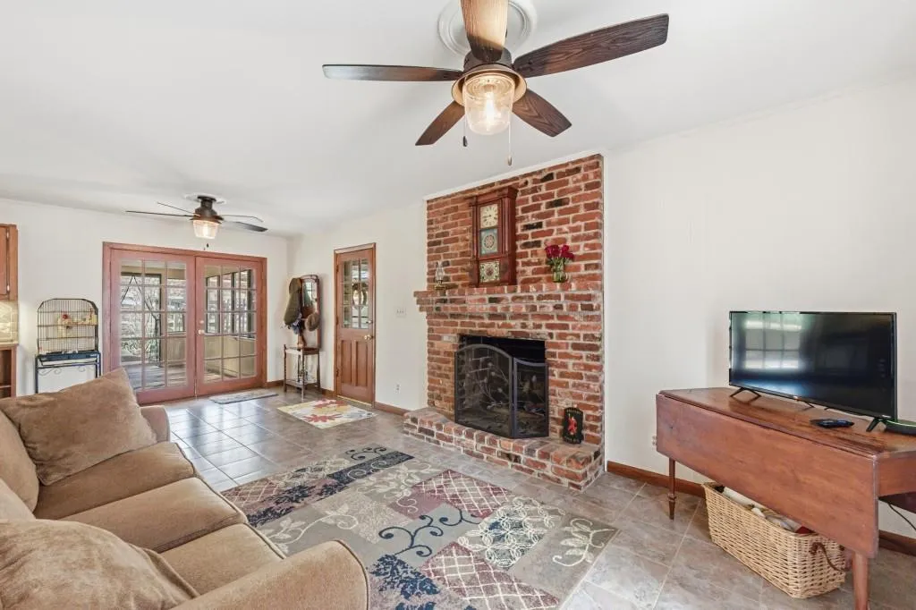 Keeping/Family Room with brick fireplace and ceramic tile floors