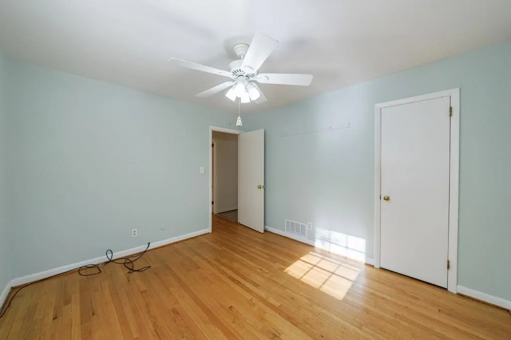 One of two secondary bedrooms with hardwood floors