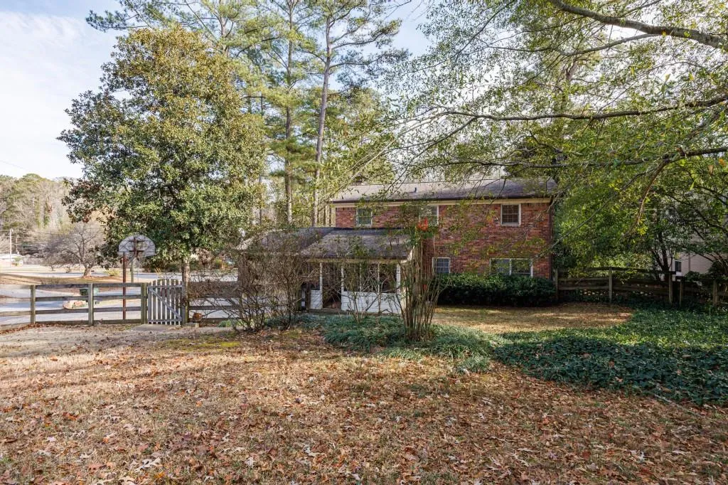 View of the back of the house form the fenced backyard