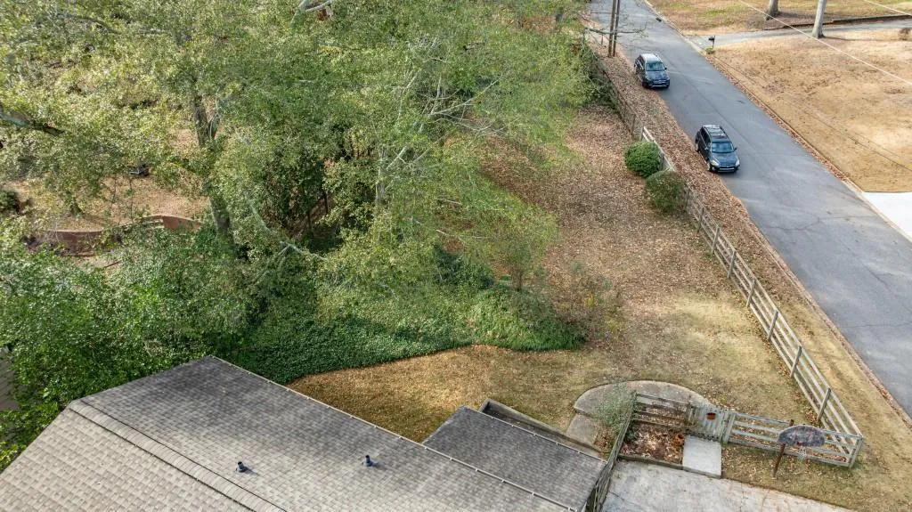 Aerial view of back of house and fenced backyard
