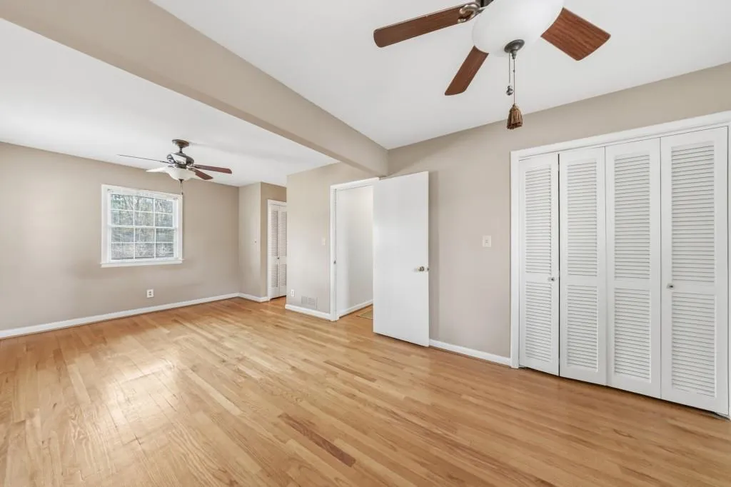Primary bedroom with hardwood floors