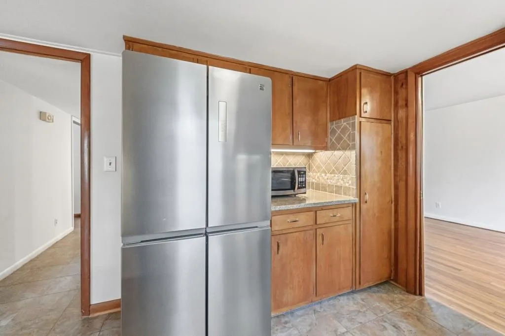 Kitchen with Quartz counters, ceramic tile backsplash and SS Appliances