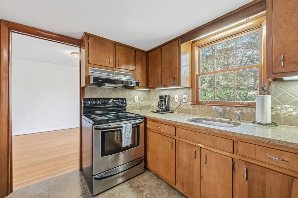 Kitchen with Quartz counters, ceramic tile backsplash and SS Appliances