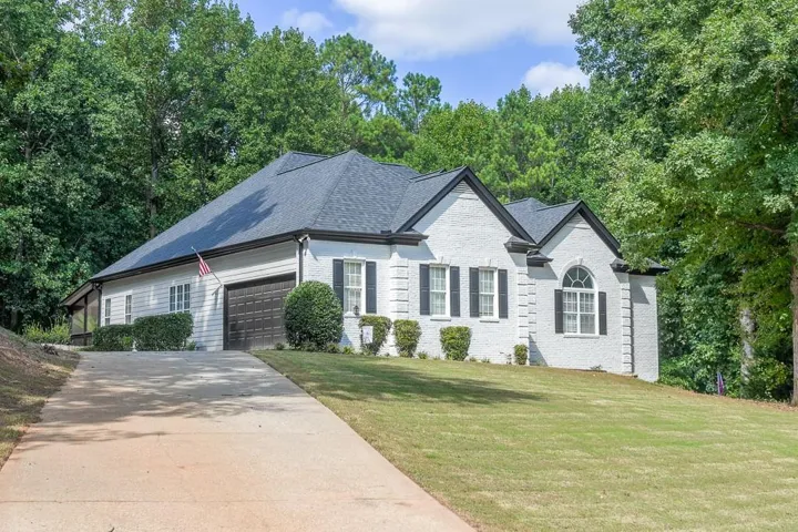 White brick exterior with black shutters and trim