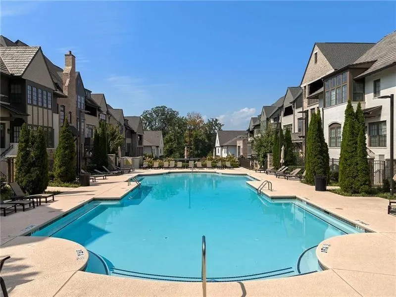 Community pool featuring a patio area and a residential view