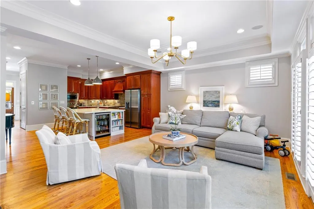 Living room with ornamental molding and light wood-type flooring