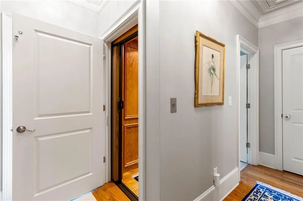 Hallway featuring ornamental molding and light hardwood / wood-style floors