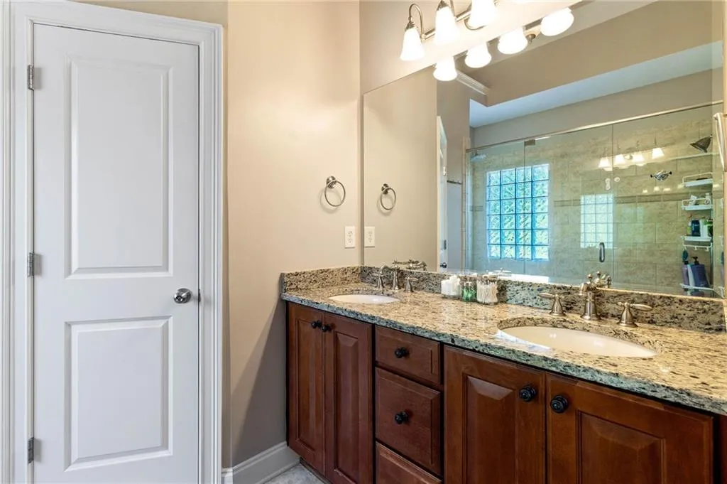 Bathroom with vanity and a shower with shower door