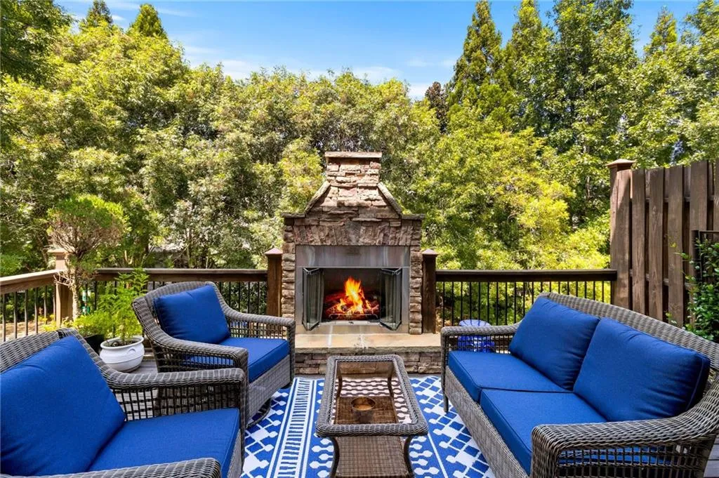 Wooden deck with an outdoor living space with a fireplace