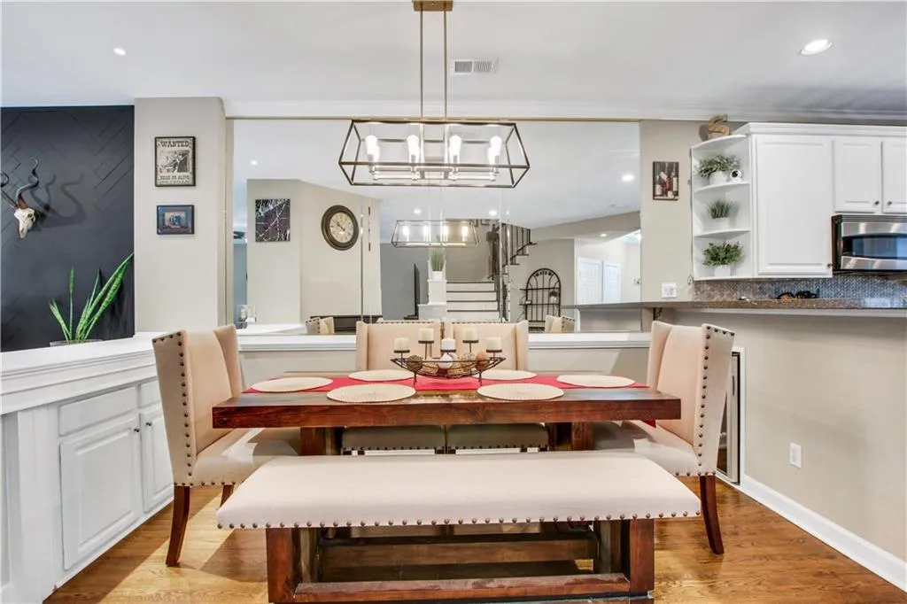 Dining area featuring light hardwood / wood-style flooring and an inviting chandelier