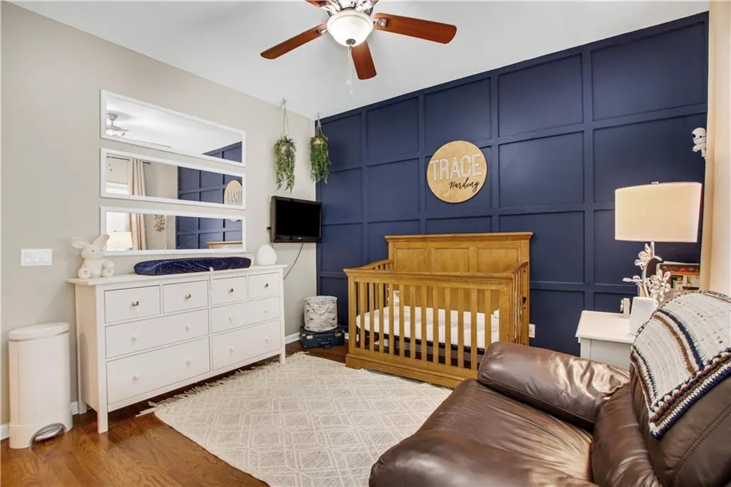 Bedroom featuring hardwood / wood-style floors and ceiling fan