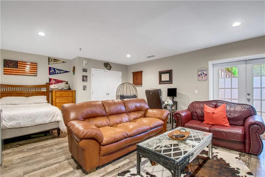 Bedroom featuring light hardwood / wood-style flooring, access to outside, and french doors