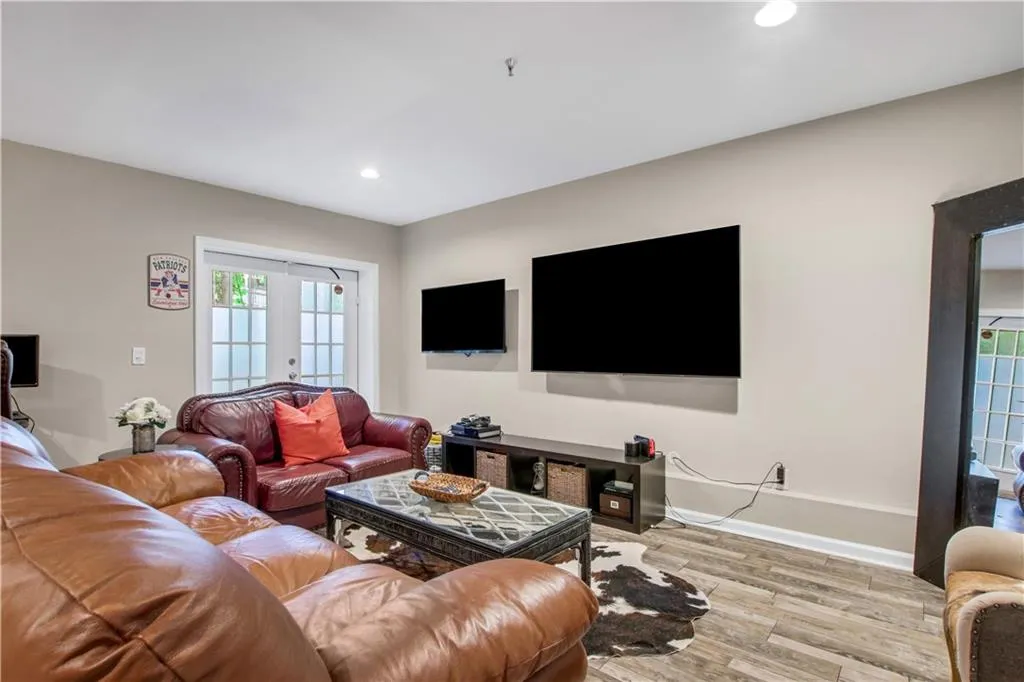 Living room with french doors and light wood-type flooring