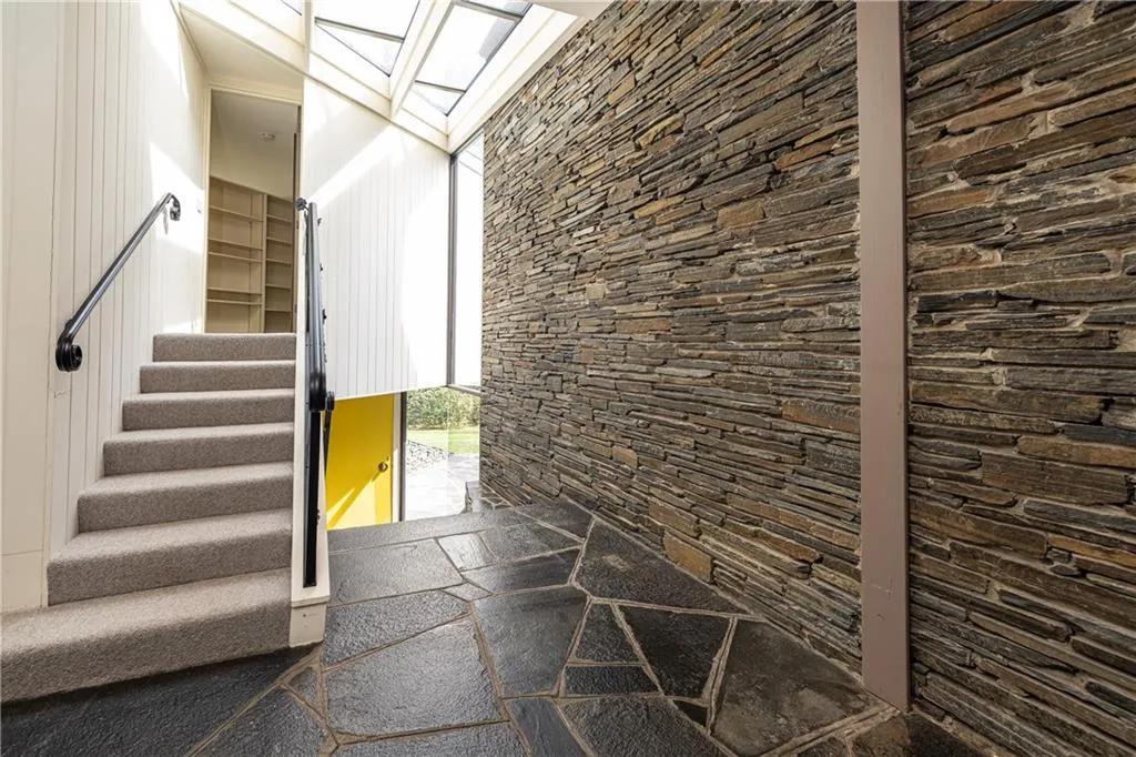 Stacked stone entry foyer with skylights to entry